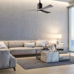 Salon contemporain lumineux avec canapés gris clair, table basse et ventilateur au plafond; ambiance calme et aérisée. A quoi sert la ventilation dans une maison est expliquée sur la page.